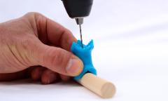 Drill a hole through a dowel rod.