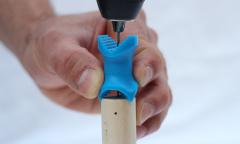 Drill a hole directly in the center of the end of a dowel rod.